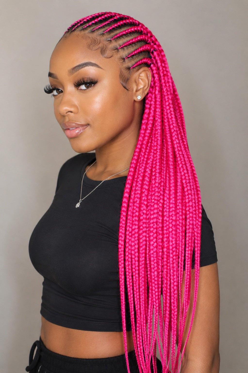Model wearing long bright pink braids made with Outre X-Pression 3X Ultra Braid