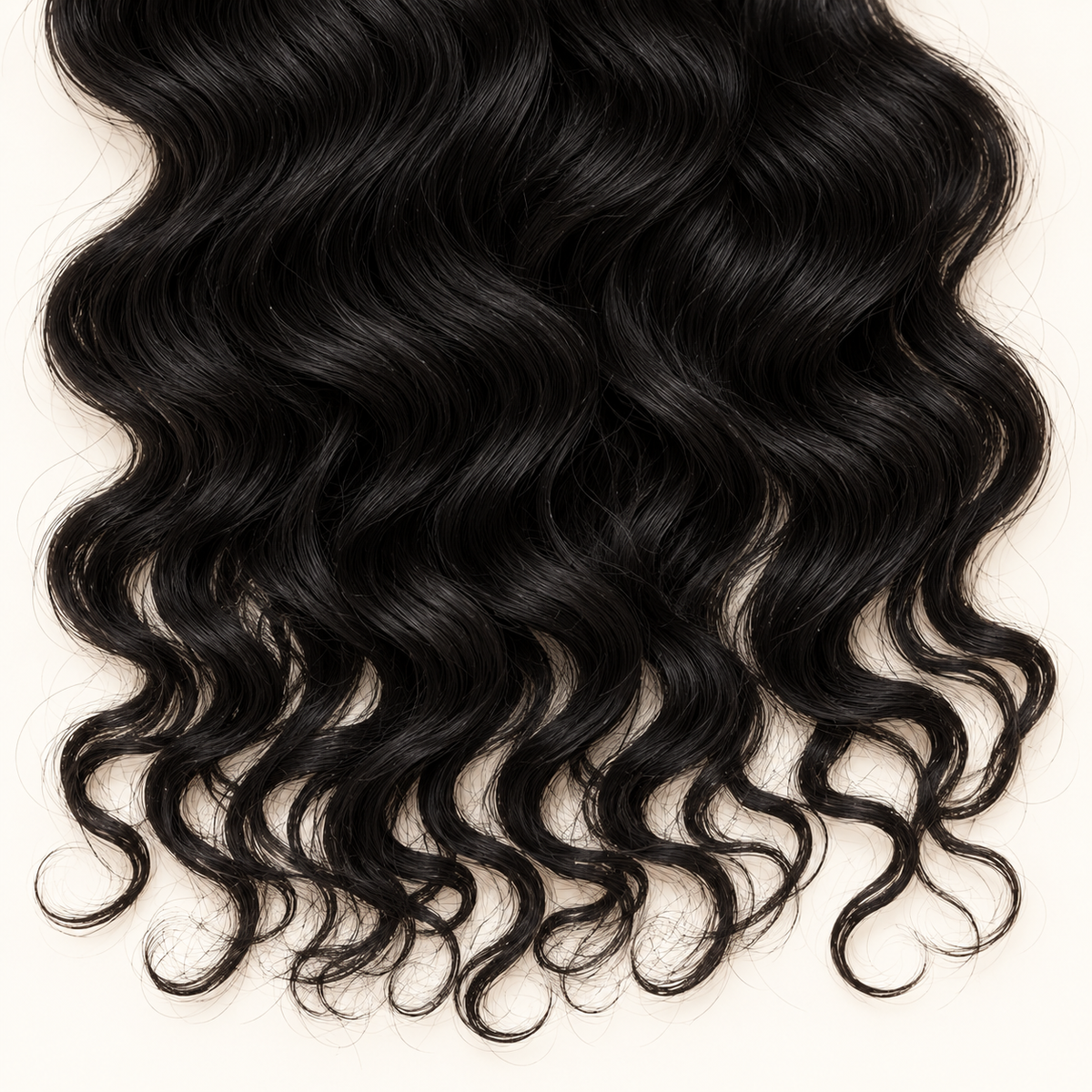Close-up of black hair waves, loose curls, and tapered ends.